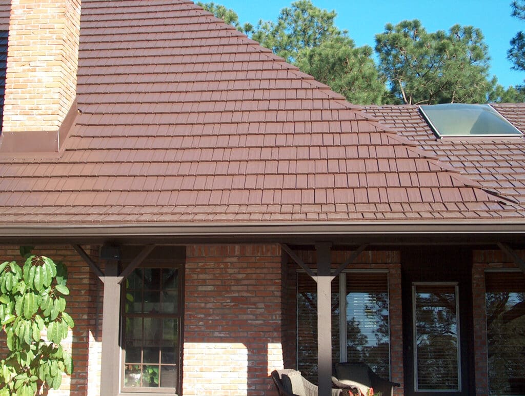 Close up of Terra Red Cedar Shake Metal Roof on brick house in Portland, OR, to illustrate metal roof types residential