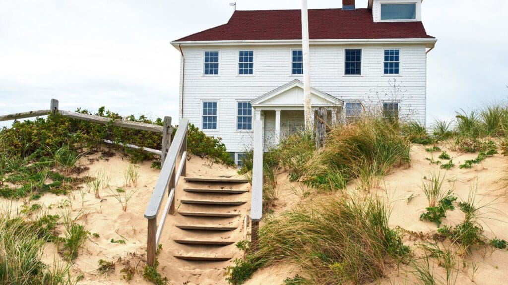 House with red metal roof on the Oregon coast to help illustrate does coastal metal roofing make sense