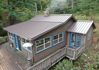 Standing seam metal roof on a home in a forested area