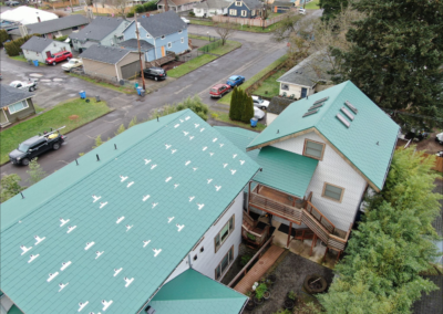 A multi-pitched classic green slate metal roof located in Vancouver, WA