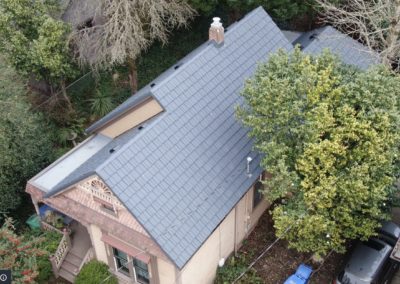 Aerial view of a gray metal roof pitched roof side