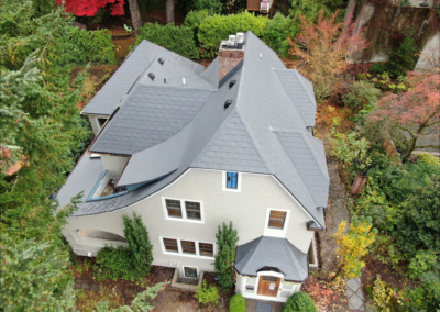 Aerial view of steep pitch gray slate metal roof