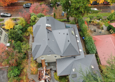 Aerial view of a gray slate metal roof with multi-pitches