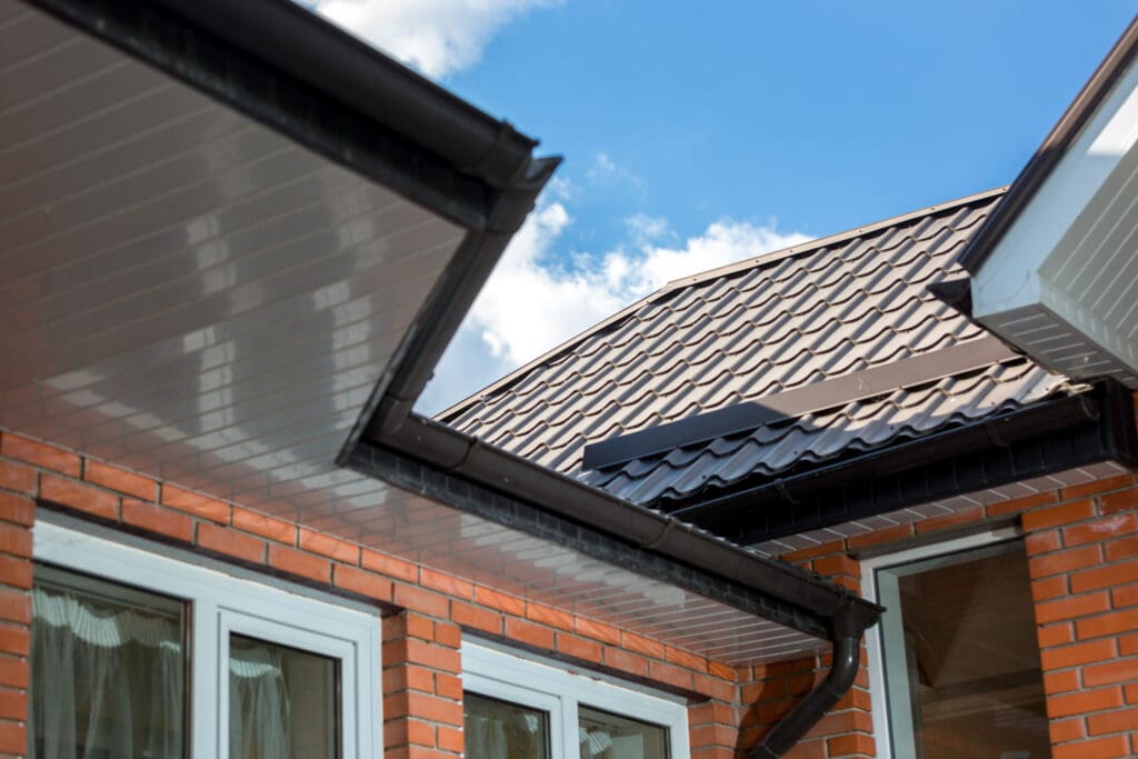 Metal house roof against bright blue sky to illustrate Do I Need Closure Strips For Metal Roofing