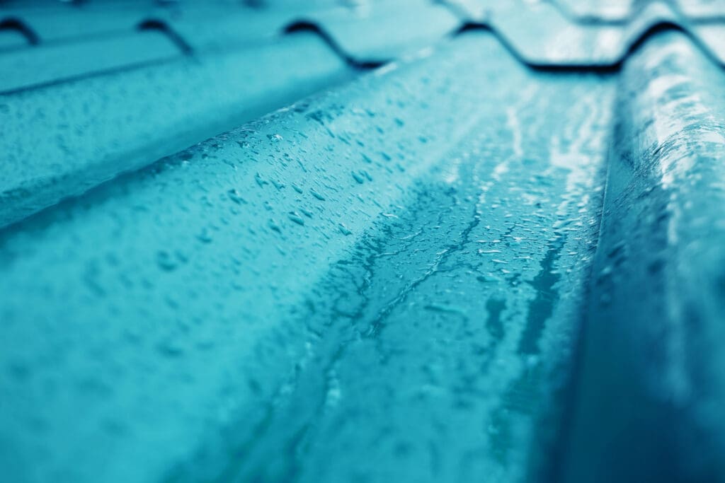 Closeup of Blue Roof Texture. Shot on Rainy Day to illustrate Is Sarking Required Under A Metal Roof