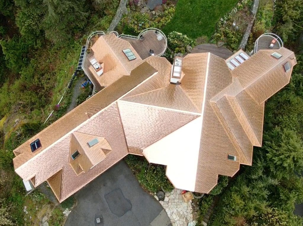 A big home with copper roofing to illustrate how much does a copper roof cost.