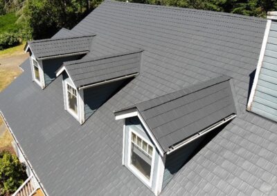 Charcoal Gray Woodgrain Shingle - Olalla, WA to illustrate types of metal roofs on homes.