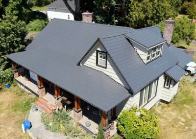 A nice home with Charcoal Grey Embossed metal roofing to illustrate how long does metal roofing last.