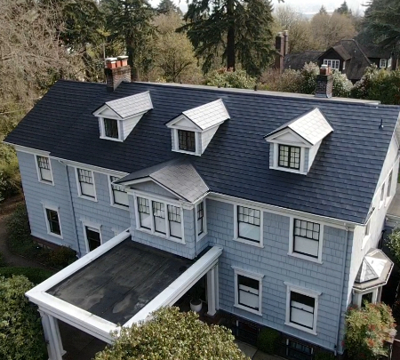 Smooth Black Shingle roof and blue siding with light trim in Portland, OR, to illustrate metal roof and siding color combinations.
